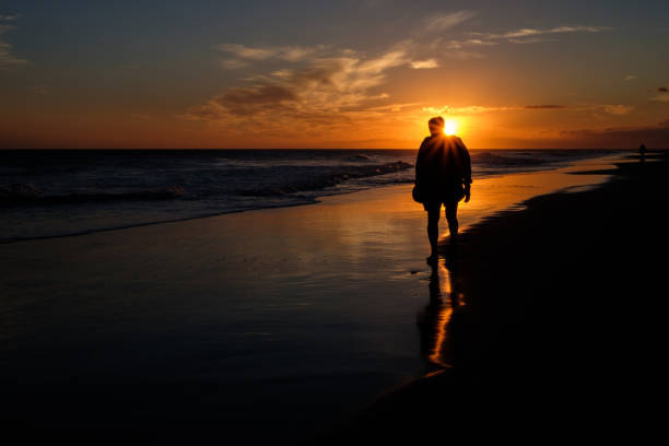 istock silhouette of man at beach 827047428