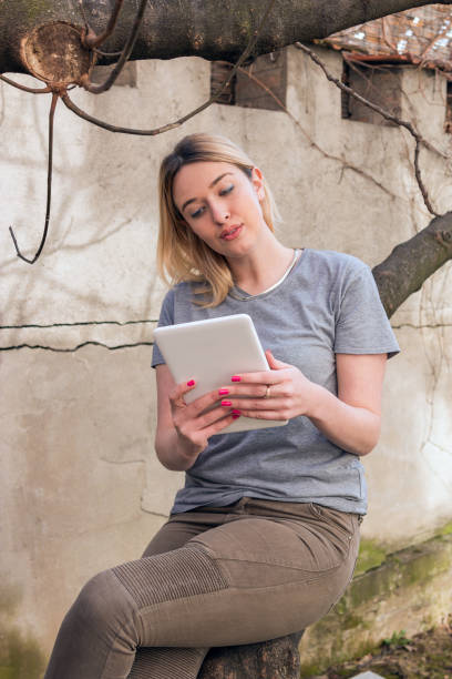 istock Beautiful woman working on a digital tablet. 827051152