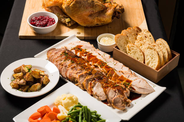 Gourmet Turkey Dinner Gourmet roasted turkey dinner with gravy, assorted vegetables, potatoes and cranberry sauce carving set stock pictures, royalty-free photos & images