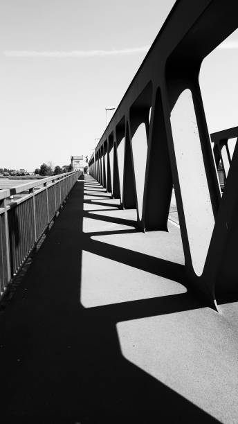istock monochrome part of architecture - bridge steel construction with shadows 827054856