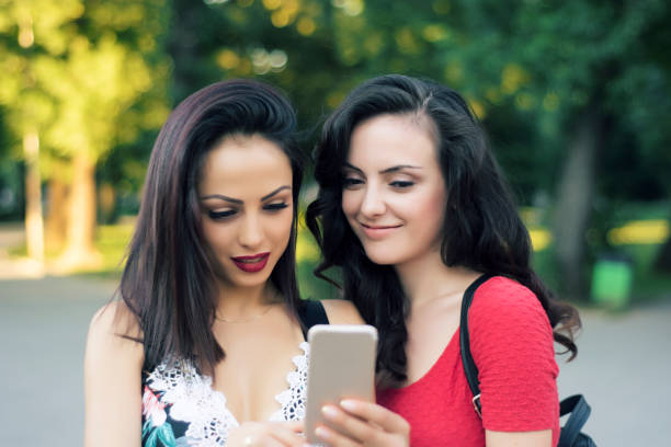 istock Girls looking phone 827072178