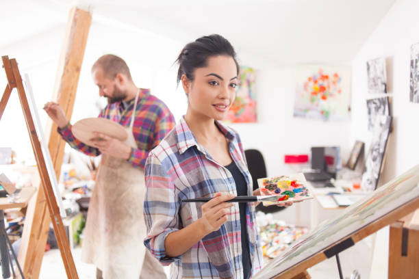 istock Couple fine artists drawing in studio 827072262