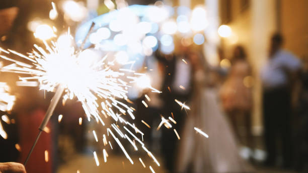 istock Fireworks in hands of guests - wedding evening 827074598