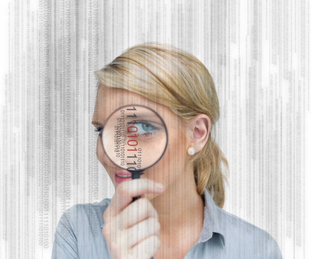 istock Woman standing holding a magnifying glass 827075272