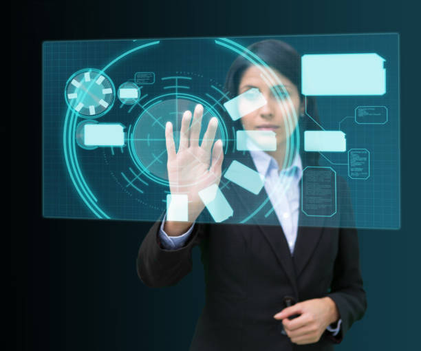 istock Businesswoman standing while touching at a hologram 827077768