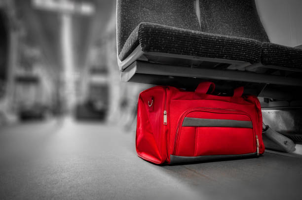 Unattended red bag left in a subway cart, train carriage or monorail. unattended bag left in a subway cart, train carriage or monorail. sabotage photos stock pictures, royalty-free photos & images