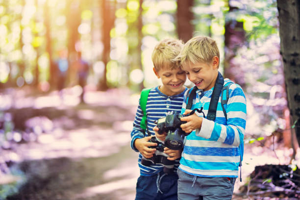 istock Littel boys photographing in forest 827084920