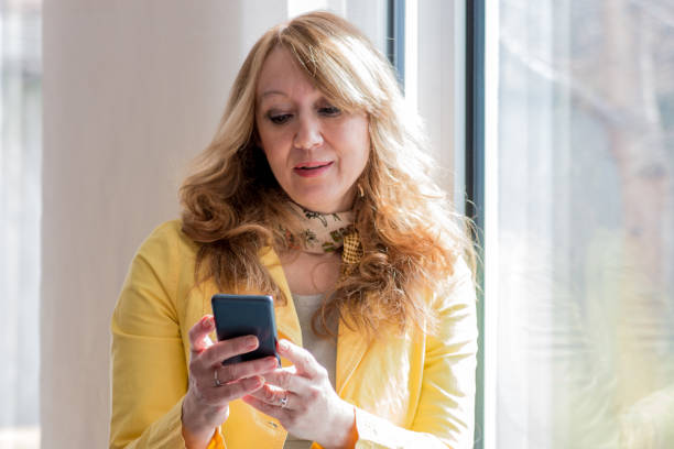 istock Woman writes a text message with her phone 827088222