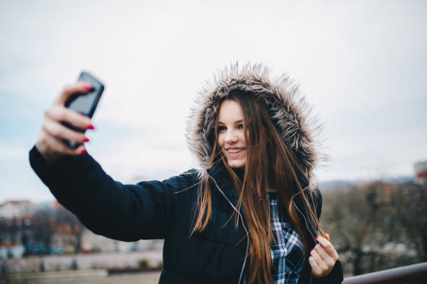 istock Woman having fun with phone 827098772
