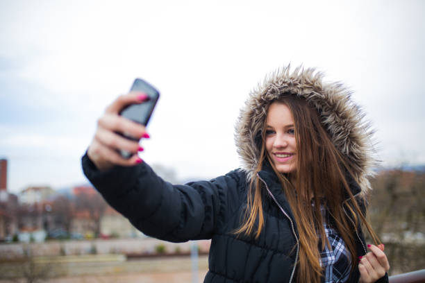 istock Woman having fun with phone 827098860