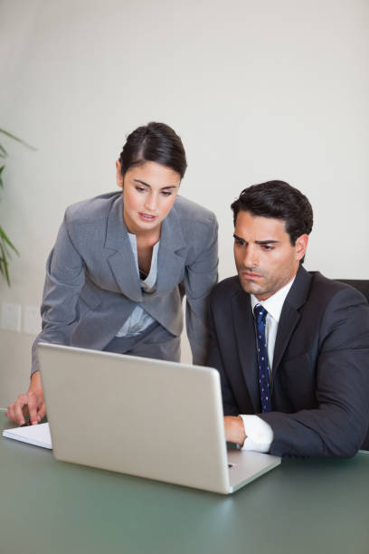 istock Portrait of sales persons working with a notebook 827099126