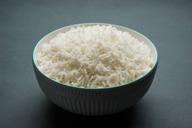 istock basmati rice in a ceramic bowl, indian white and long basmati rice cooked and served in bowl, selective focus 827099414