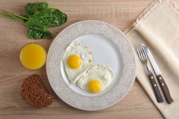 scrambled eggs with spinach on the plate - a healthy Breakfast with orange juice