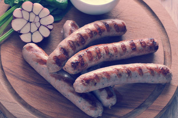 istock grilled bratwurst sausages with sauce, spinach and garlic 827106830