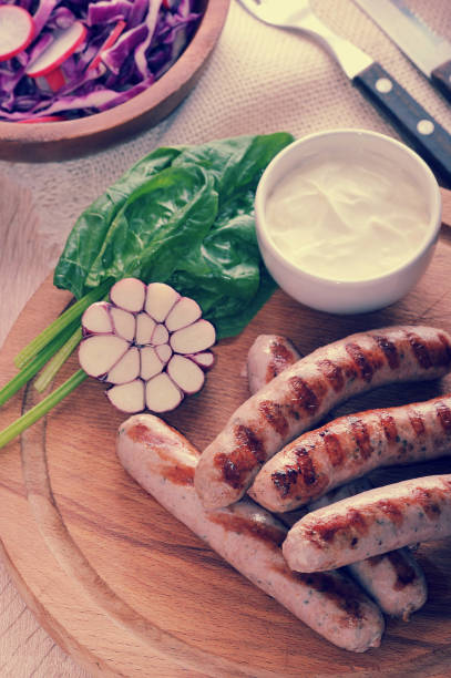 istock grilled sausages with sauce, spinach and garlic 827106974