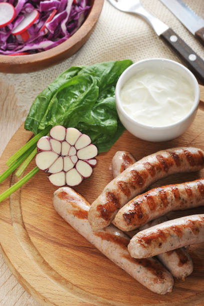 istock grilled sausages with sauce, spinach and garlic 827107008