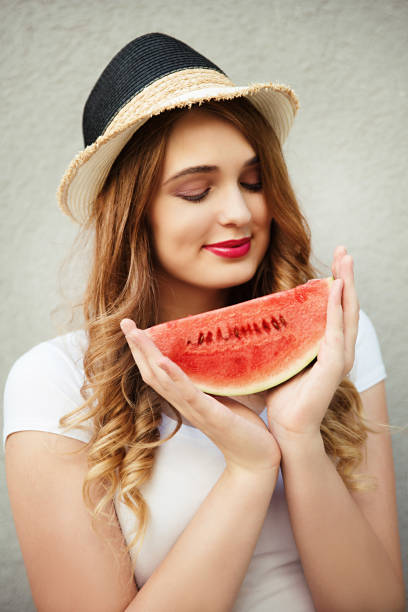 istock Young woman holding  watermelon 827107500