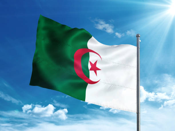 istock Algeria flag waving in the blue sky 827116436