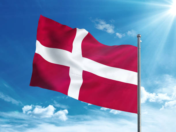 istock Denmark flag waving in the blue sky 827116536