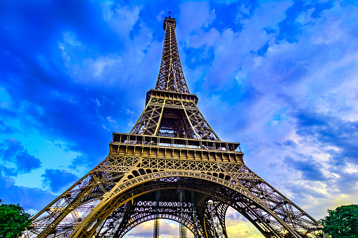 Paris, France, Eiffel Tower, illuminated at sunset The Eiffel Tower was built in 1889, and is a popular attraction for tourists.