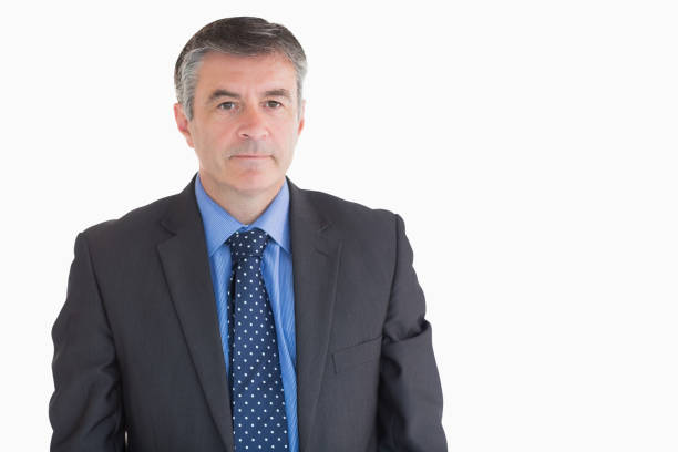 Businessman looks serious against the dark glass and steel of an office building