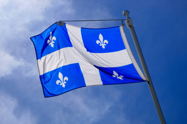 istock Quebec Flag pole on blue sky national st-jean banner 827122796