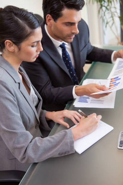 istock Portrait of sales persons studying statistics 827126356