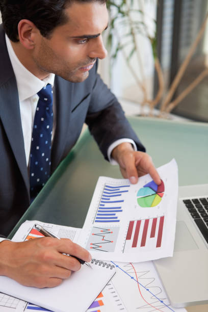 istock Portrait of a sales person studying statistics 827128412