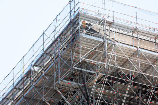 istock Closeup construction of office building with security mesh and scaffolding 827135304