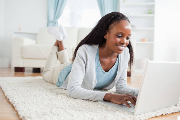 istock Woman lying on the floor with her notebook 827144690
