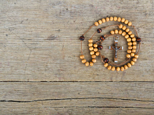 istock Rosary beads on the old wooden table 827145162