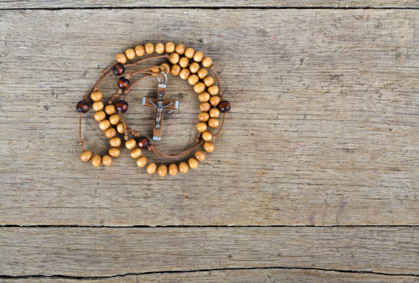 istock Rosary beads on the old wooden table 827145164
