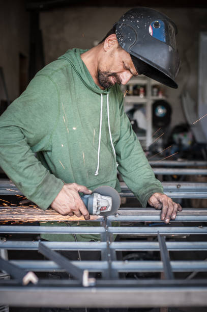 istock Electric wheel grinding on steel structure in factory 827145404