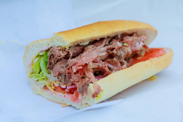 istock Beef sandwich with tomato and salad on a table. 827145412