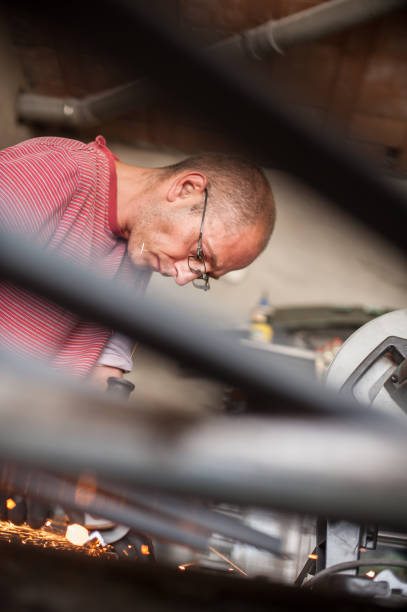 istock Electric wheel grinding on steel structure in factory 827145488