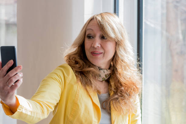 istock Woman taking self portrait at home. 827151254