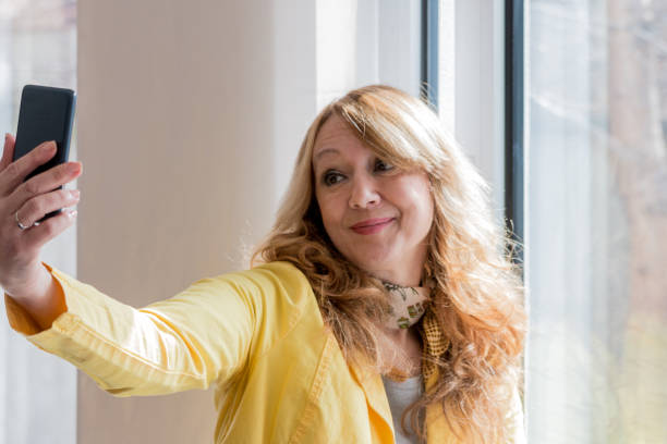 istock Woman taking self portrait at home. 827151290