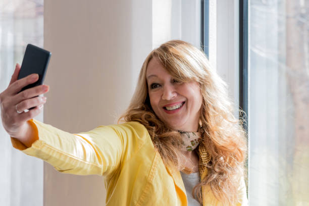 istock Woman taking self portrait at home. 827151320