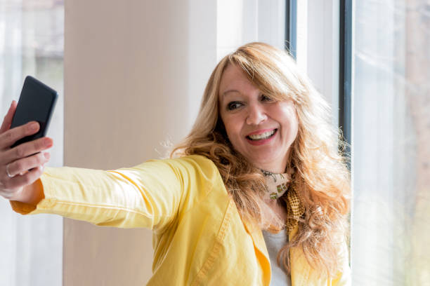 istock Woman taking self portrait at home. 827151342