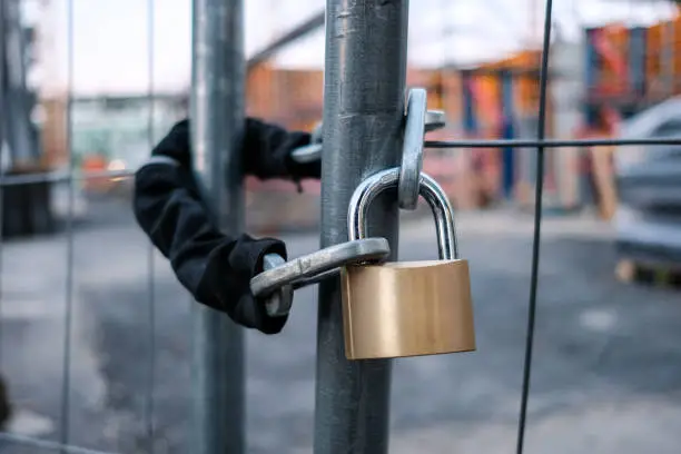 Photo of chain and padlock on gate at construction site