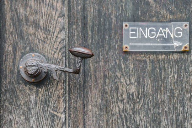 istock Vintage door handle on a wooden front door 827164108