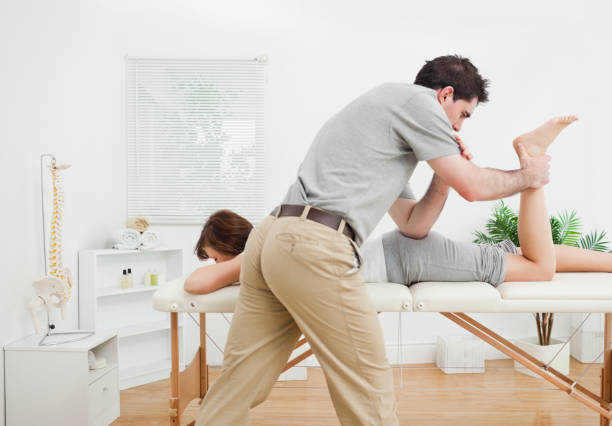 istock Brunette woman being stretched by a physiotherapist 827173864