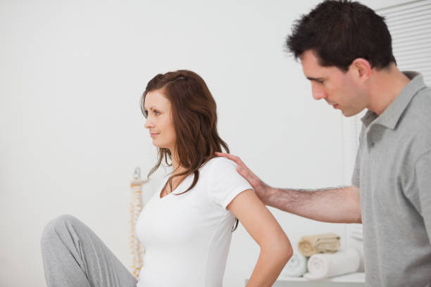 istock Woman sitting while a man is touching her back 827174224
