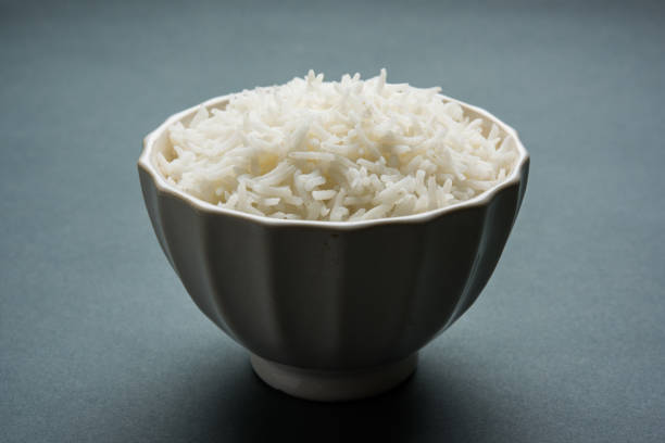 istock basmati rice in a ceramic bowl, indian white and long basmati rice cooked and served in bowl, selective focus 827174250