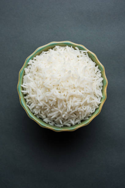 istock basmati rice in a ceramic bowl, indian white and long basmati rice cooked and served in bowl, selective focus 827176914