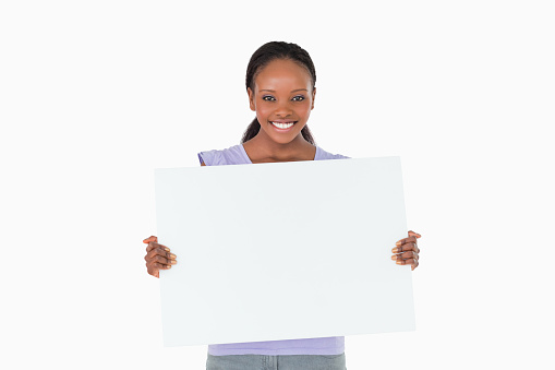 Smiling woman holding placeholder in her hands on white background