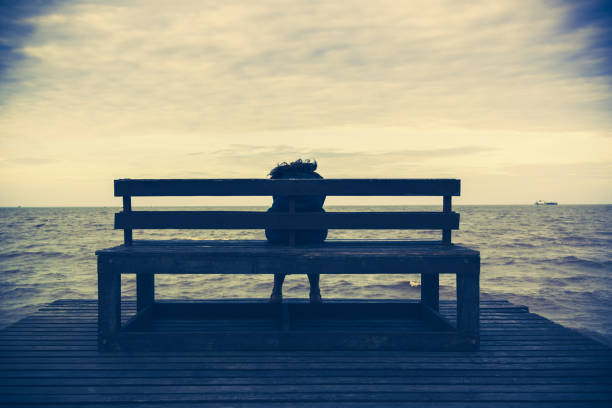 istock Women sits on a wooden chair 827180914
