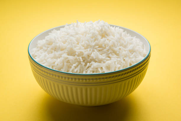istock basmati rice in a ceramic bowl, indian white and long basmati rice cooked and served in bowl, selective focus 827187250