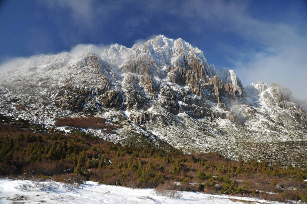 istock Mountain with snow partly covered in mist 827187654