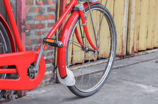istock bicycle red  classic vintage in former on wall wood background with copy space for add text 827190374